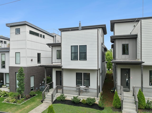 view of front of home with central AC unit and covered porch