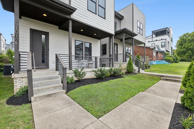 exterior space featuring central AC unit and a lawn