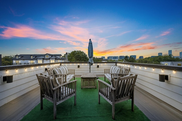 patio terrace at dusk featuring a yard