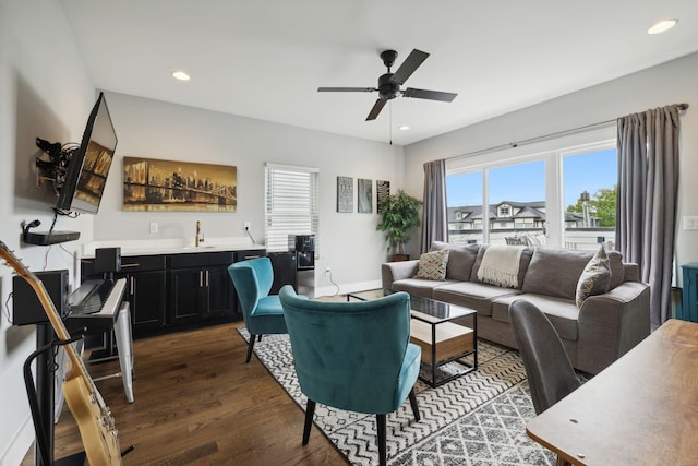 living room with dark wood-type flooring, wet bar, and ceiling fan