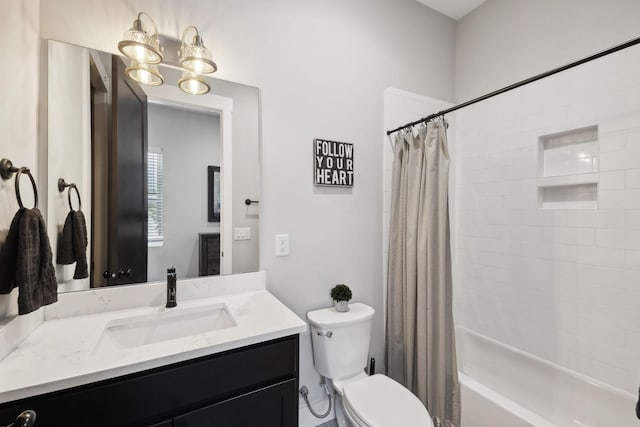 full bathroom with vanity, shower / tub combo, and toilet