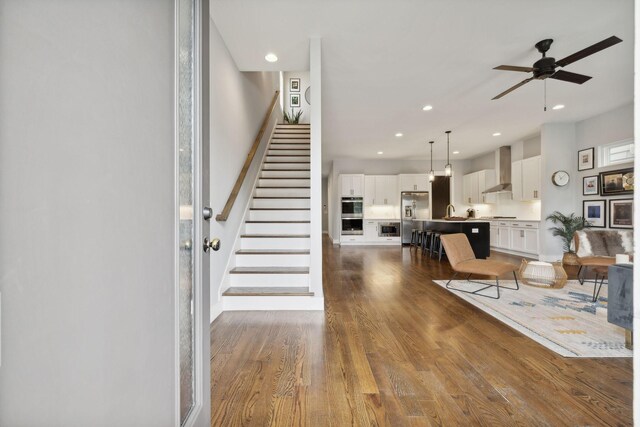 living room with dark hardwood / wood-style floors and ceiling fan