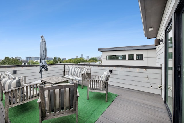 wooden terrace featuring an outdoor living space