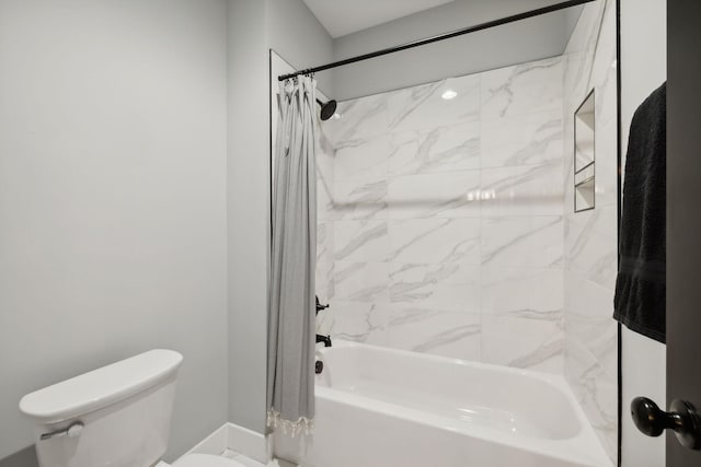 bathroom featuring shower / bath combination with curtain and toilet