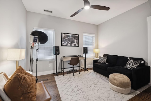 living room featuring hardwood / wood-style flooring, a wealth of natural light, and ceiling fan