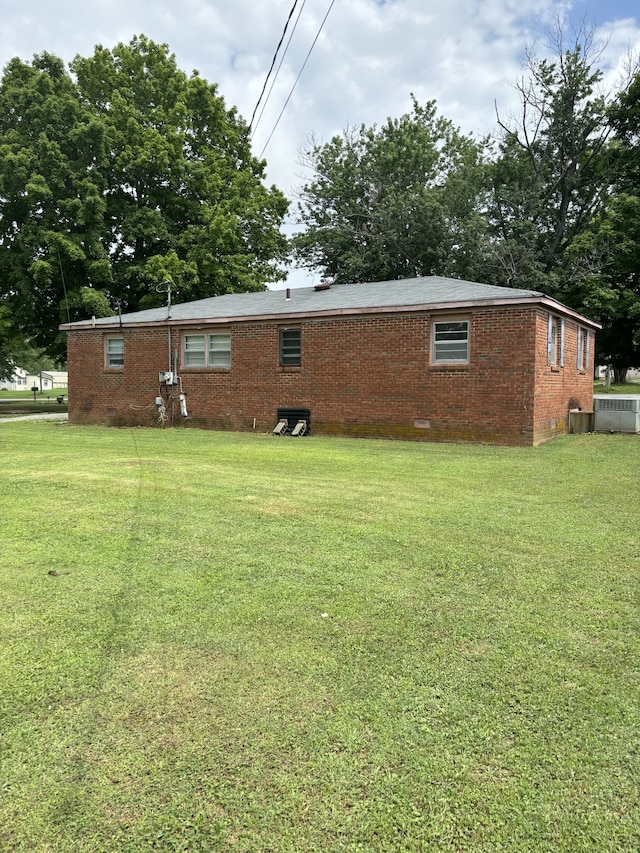 view of property exterior featuring a lawn and central air condition unit