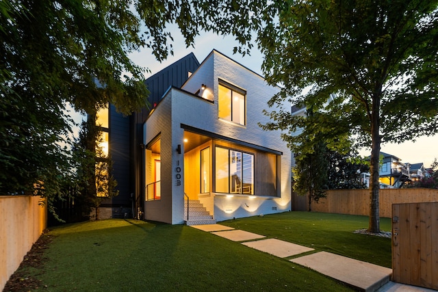 back house at dusk with a yard