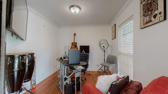 home office featuring ornamental molding, hardwood / wood-style floors, and a textured ceiling