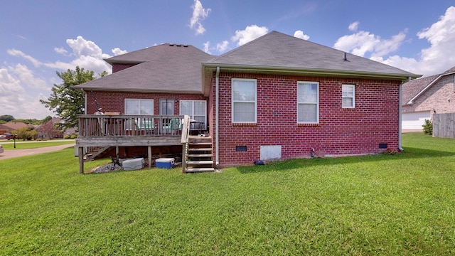 rear view of house featuring a wooden deck and a yard