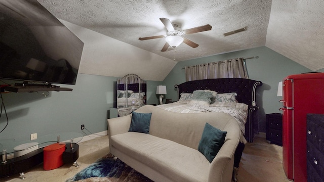 bedroom with fridge, ceiling fan, lofted ceiling, and a textured ceiling