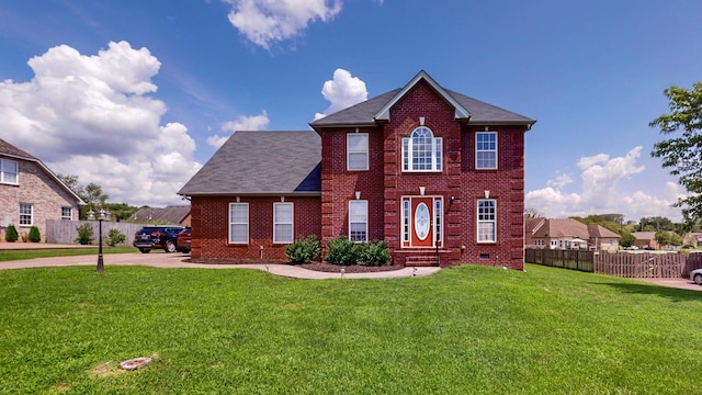 colonial inspired home featuring a front lawn