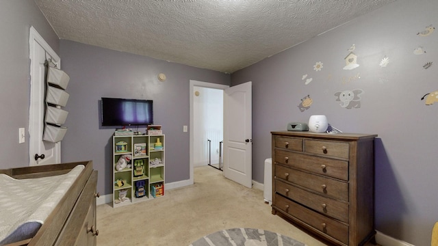 carpeted bedroom featuring a textured ceiling