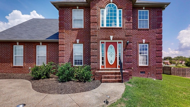 colonial-style house with a front lawn