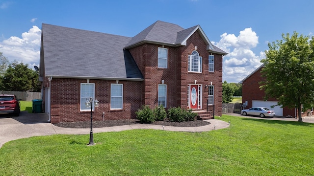 view of front of house featuring a garage and a front lawn