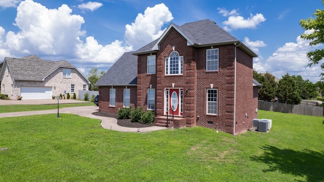 view of front facade featuring a garage, a front yard, and central air condition unit