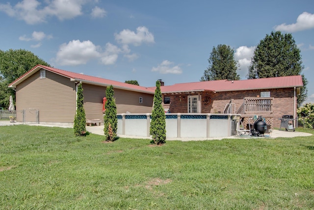 back of property featuring a lawn