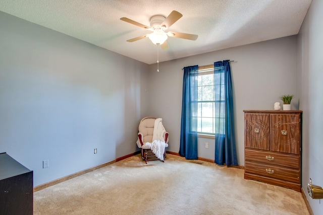 unfurnished room featuring light carpet, ceiling fan, and a textured ceiling