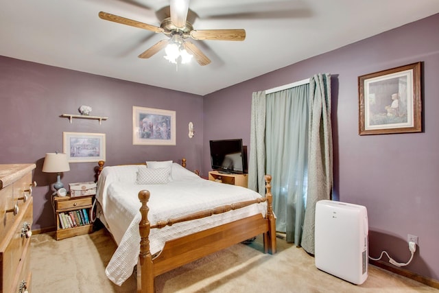 bedroom with light carpet and ceiling fan