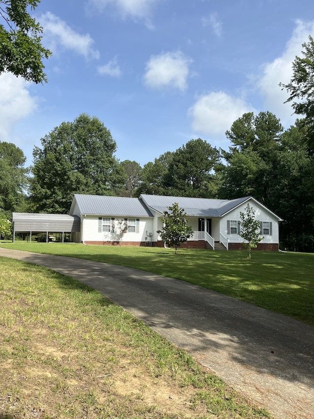 ranch-style house with a carport and a front yard