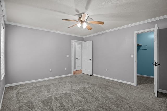 unfurnished bedroom featuring a spacious closet, carpet floors, ceiling fan, and a closet