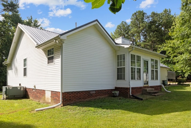 view of home's exterior featuring a yard and central air condition unit