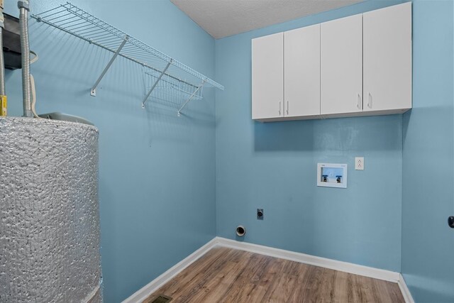 laundry room featuring cabinets, wood-type flooring, hookup for an electric dryer, and washer hookup