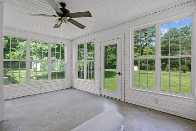 unfurnished sunroom featuring ceiling fan