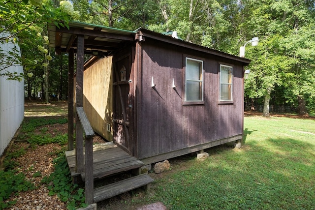 view of outdoor structure featuring a lawn