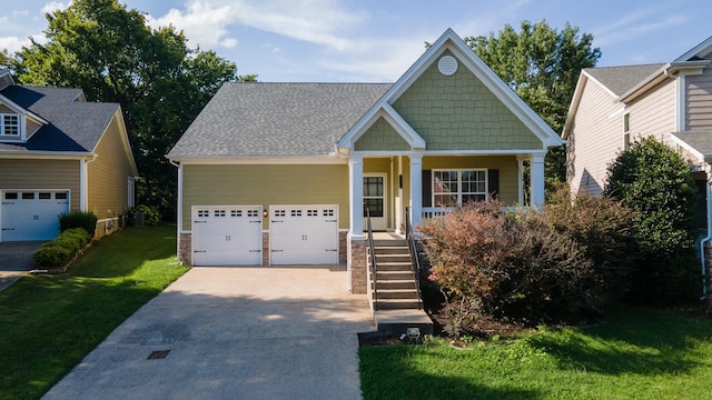 craftsman inspired home with a porch, concrete driveway, an attached garage, and a front lawn