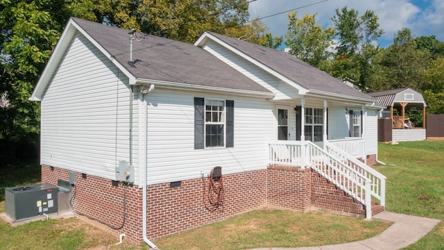 view of front facade with a gazebo, a front yard, and central air condition unit