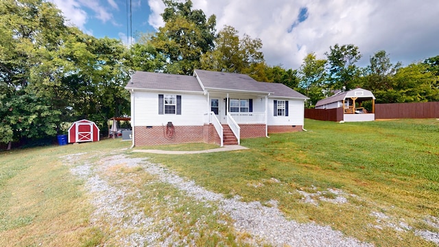 view of front of house with a storage shed and a front yard