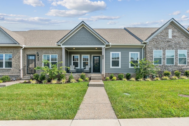 view of front of property with covered porch and a front lawn