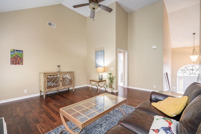 living room with ceiling fan, high vaulted ceiling, and dark wood-type flooring