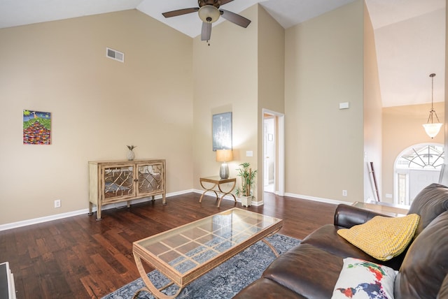 living room with dark wood-type flooring, ceiling fan, and high vaulted ceiling