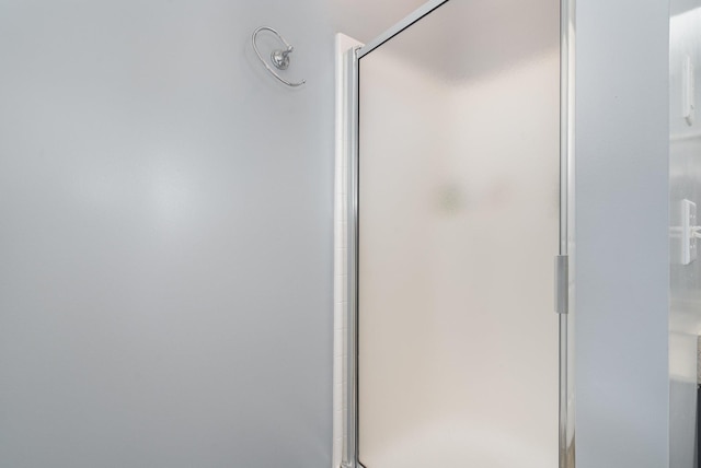 bathroom with a shower with door