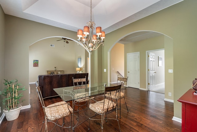 dining room featuring dark wood-type flooring and ceiling fan with notable chandelier