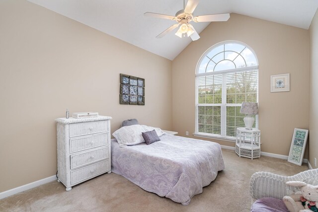 bedroom with light carpet, ceiling fan, and vaulted ceiling