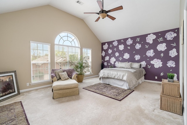 carpeted bedroom with ceiling fan and high vaulted ceiling