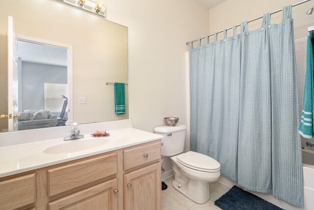 full bathroom featuring shower / tub combo with curtain, vanity, tile patterned floors, and toilet