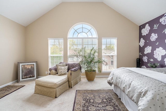 bedroom featuring light carpet, multiple windows, and high vaulted ceiling