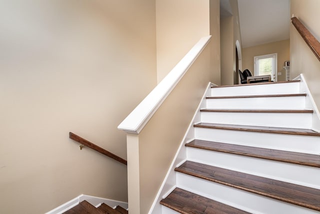 stairway featuring a skylight and wood-type flooring