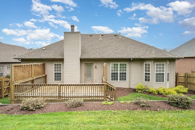 back of house with a yard and a deck