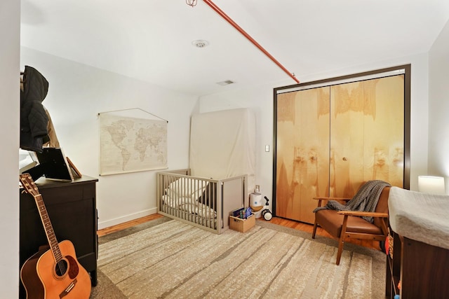 bedroom featuring a closet and light wood-type flooring