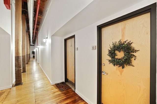 corridor featuring wood-type flooring