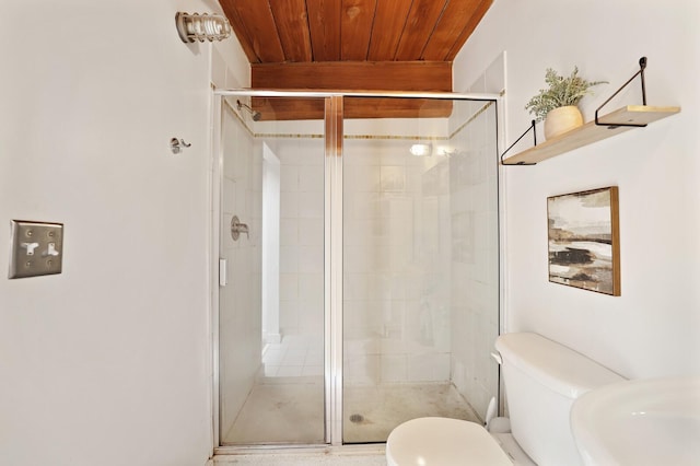 bathroom with wood ceiling, toilet, and a shower with shower door