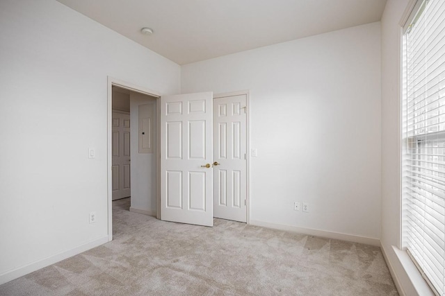 unfurnished bedroom featuring light carpet