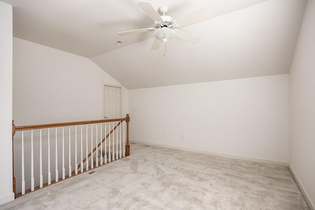 bonus room with ceiling fan, vaulted ceiling, and light carpet