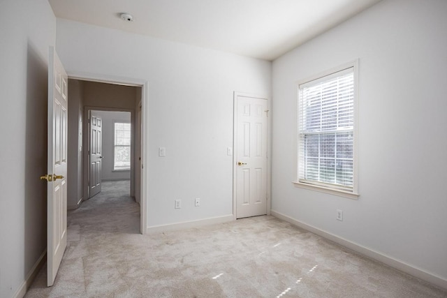 unfurnished bedroom featuring light colored carpet