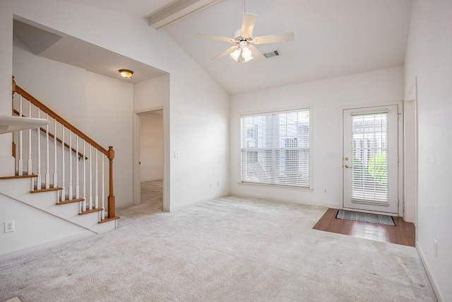 interior space featuring light carpet, ceiling fan, high vaulted ceiling, and beamed ceiling