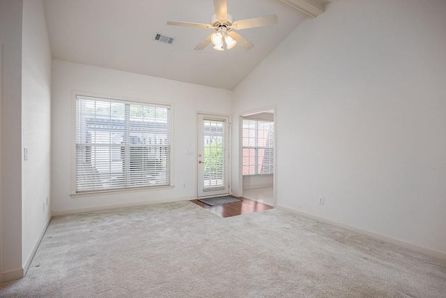 unfurnished room featuring beamed ceiling, ceiling fan, high vaulted ceiling, and light carpet